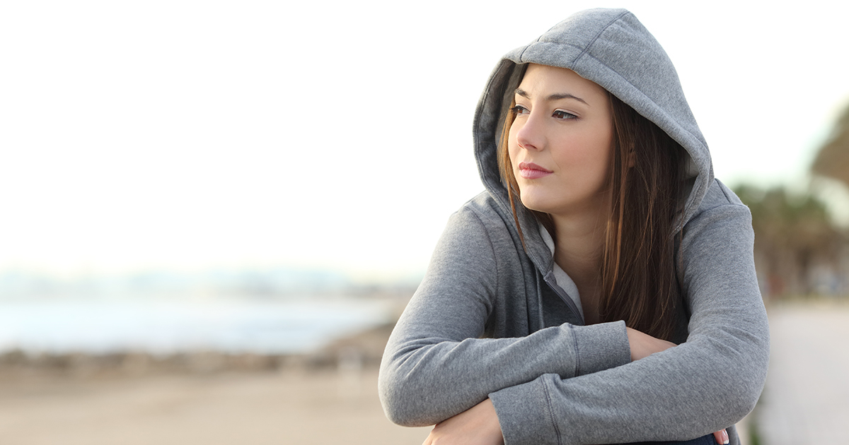 Concerned girl on the beach